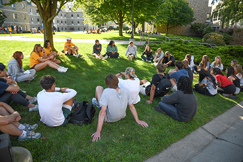 Orientation group sitting together in the quad during Welcome Weekend.