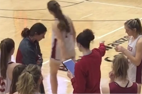 A basketball coach uses the iPad during practice.