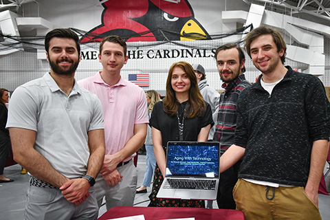 A group of students share their research at the Fisher Showcase.