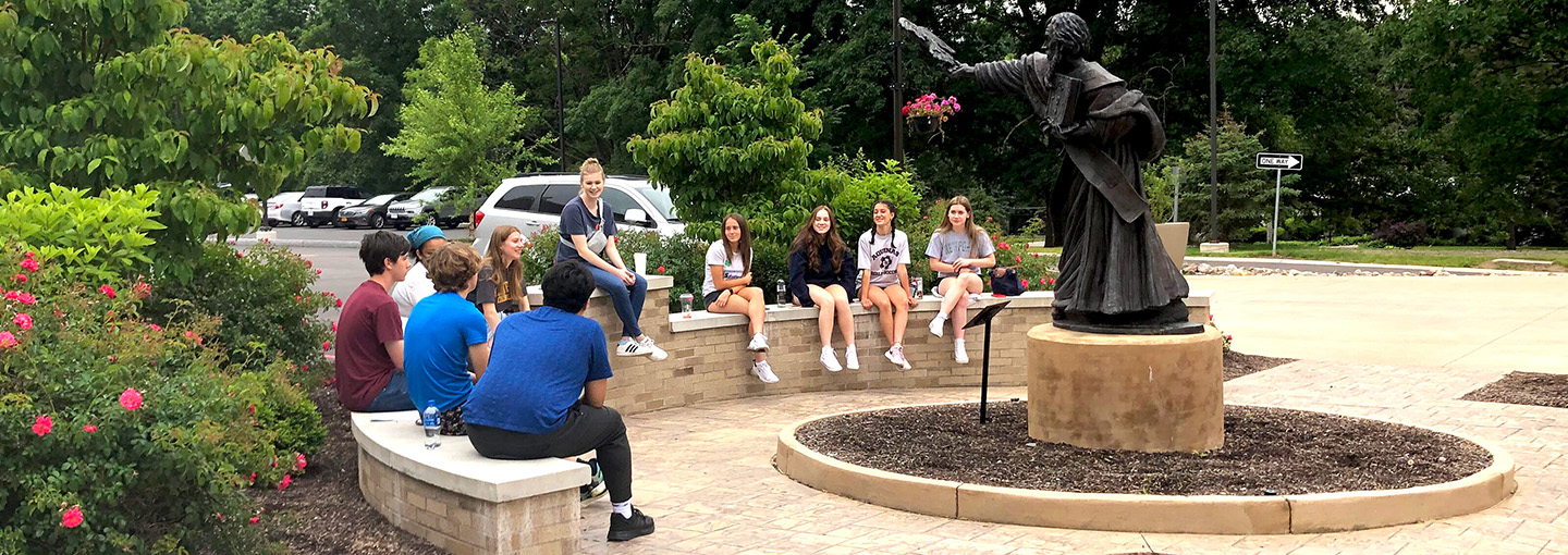 Students seated together in front of the Hermance Family Chapel of St. Basil Great.
