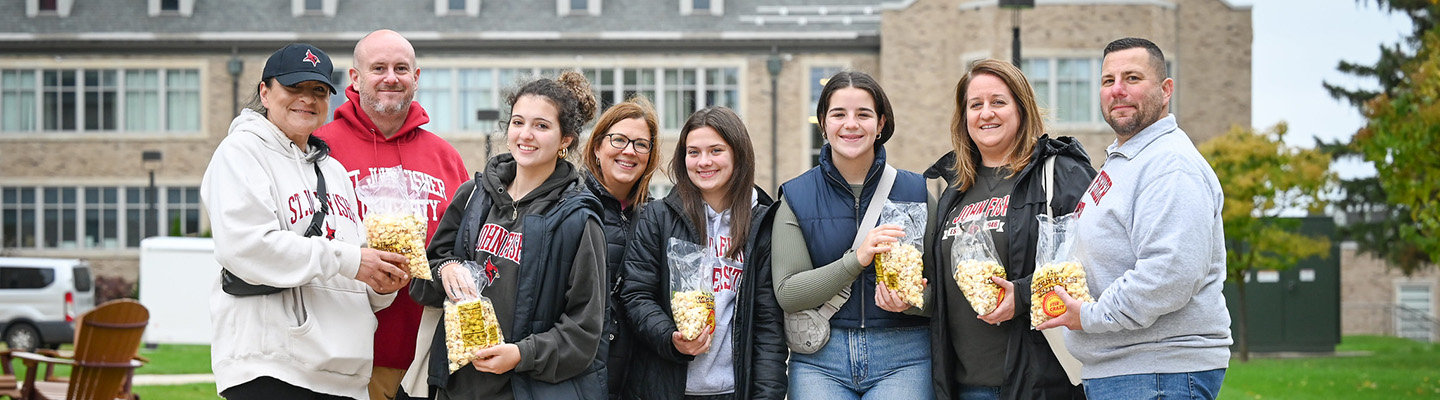 A family with popcorn during Fisher's Family Weekend.