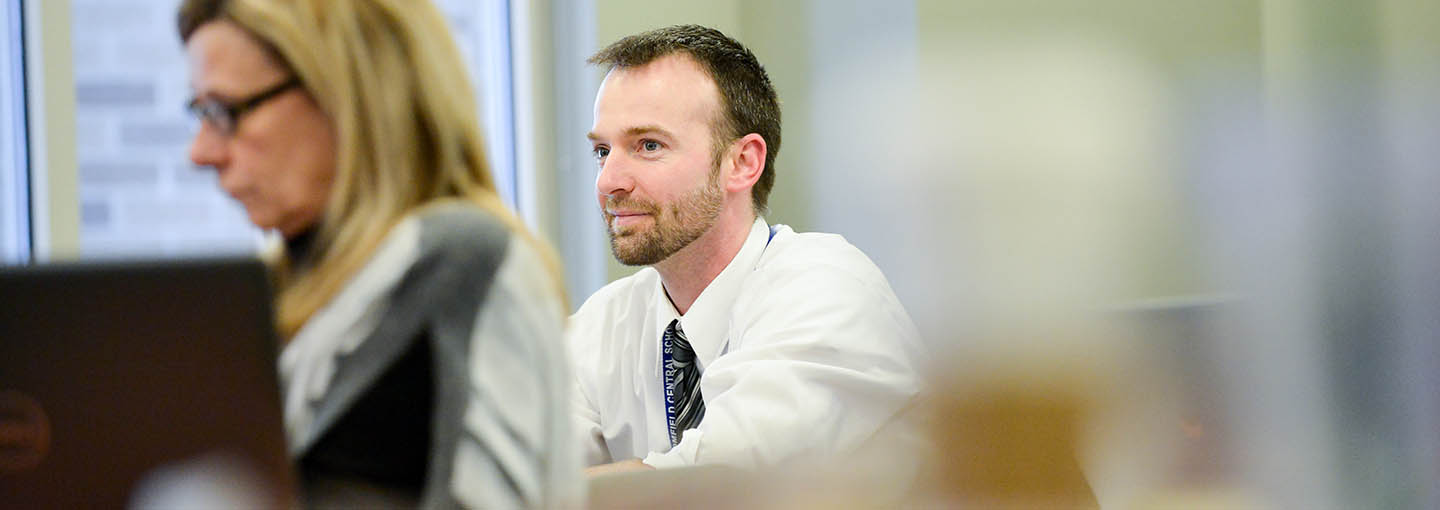 A student sits pensively in class.