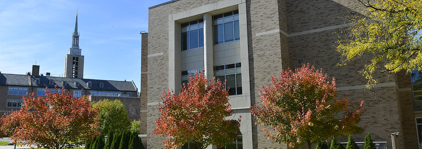 School of Pharmacy and Kearney Hall steeple with fall trees.