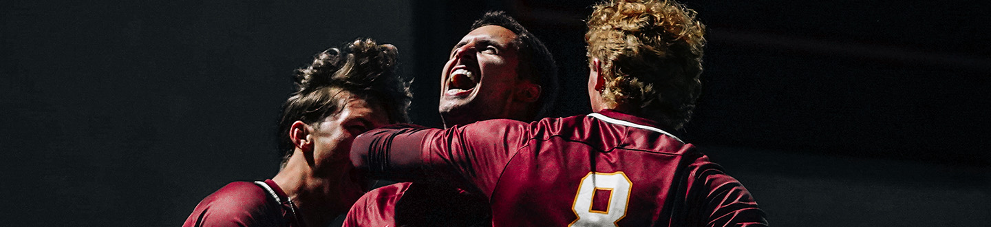 Fisher soccer team members celebrate a goal.