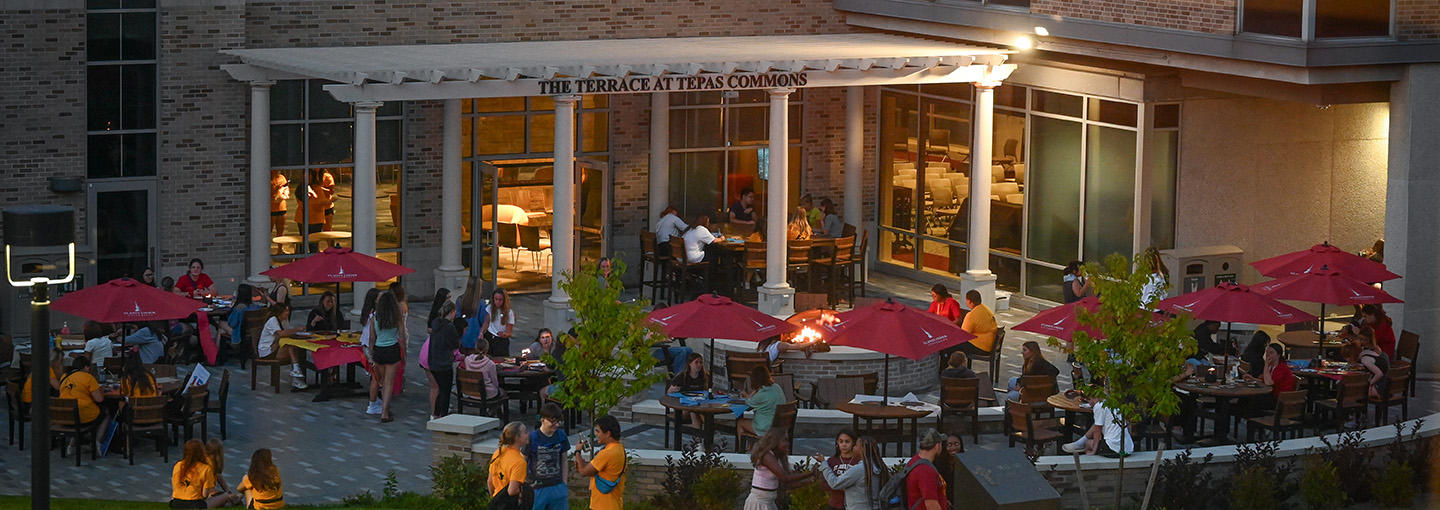 Students mingle and chat with one another at the Terrace at Tepas Commons on the St. John Fisher University campus