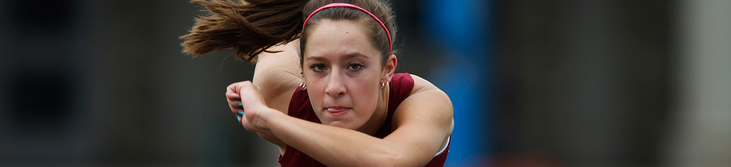 A Fisher student athlete clears the hurdles.