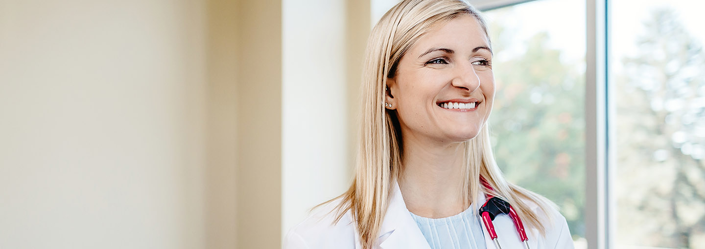 Smiling nurse looking off in the distance.