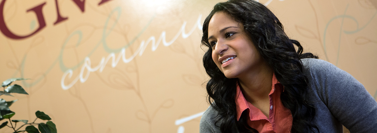 Side view of smiling student in cardigan