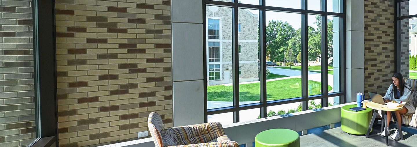 Student at table studying in brightly lit area of Lavery Library.
