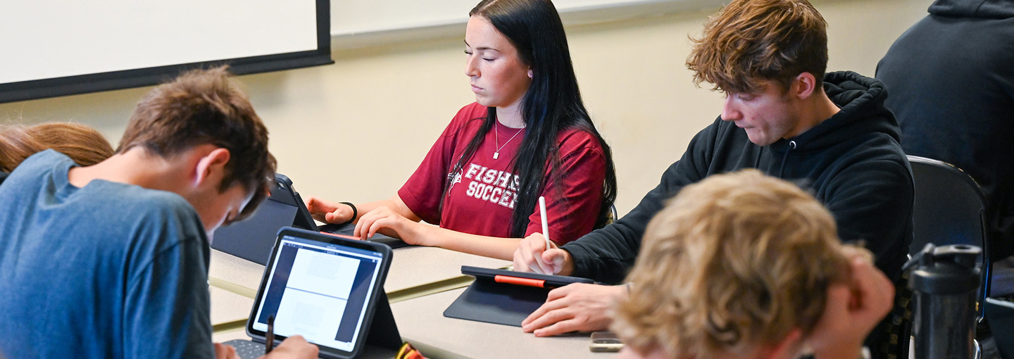 Students in classroom studying political science with iPads.