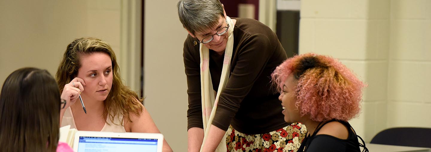 Professor VanderBuilt engaging with students in the classroom.