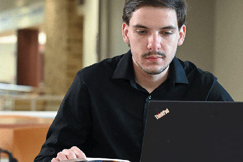 A student working on a laptop.