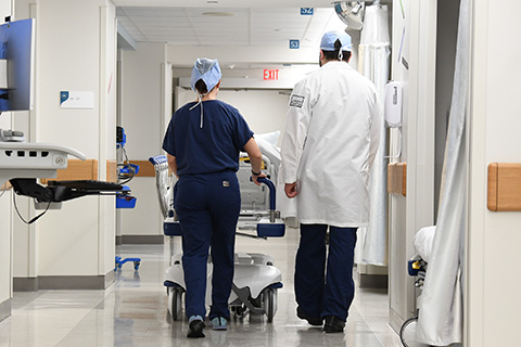 Nurses walk down the hallway in a hospital.