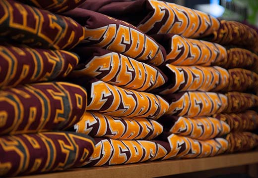 Fisher sweatshirts folded at the Cardinal Shop (University Bookstore).