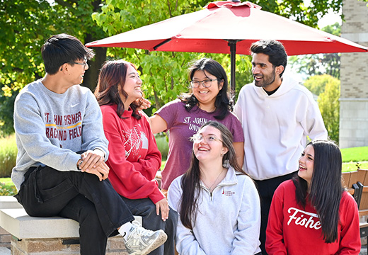 Students laughing together on campus at Fisher.
