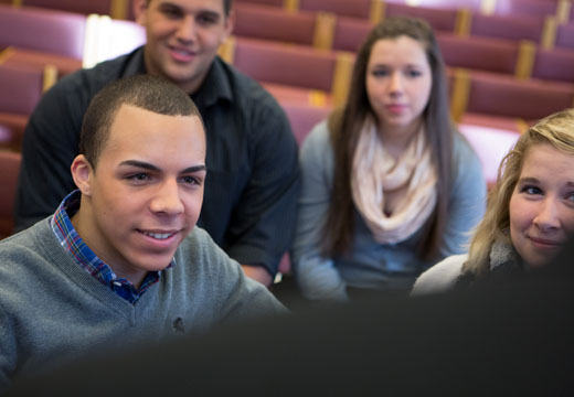 Students listen to Father Joe in Coleman Chapel.