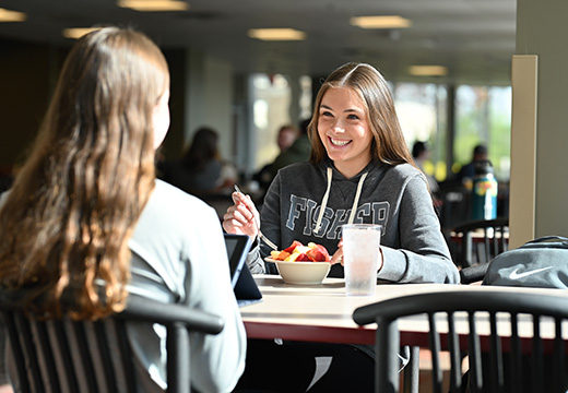 Students eating in the dining hall together.