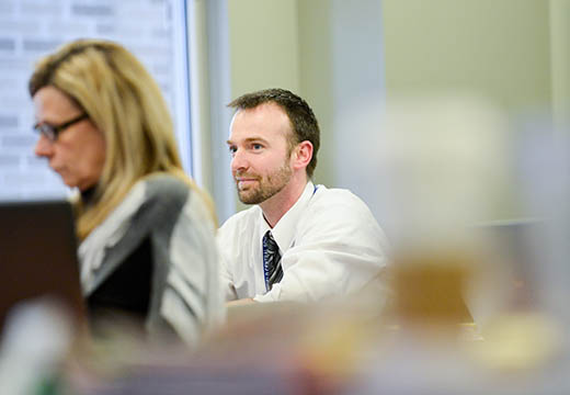 A student sits pensively in class.