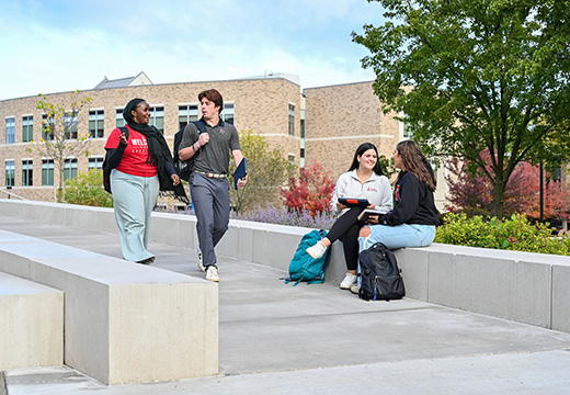Students walk together on St. John Fisher University campus.