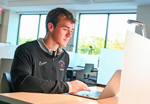 A student working on a laptop.