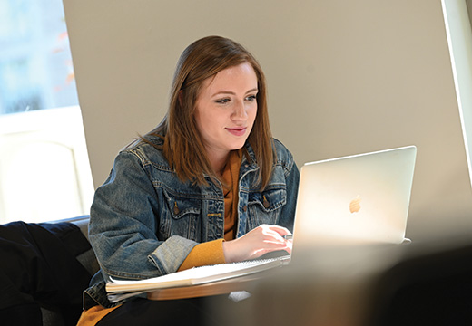 A student studies at a computer.