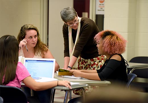 Professor VanderBuilt engaging with students in the classroom.