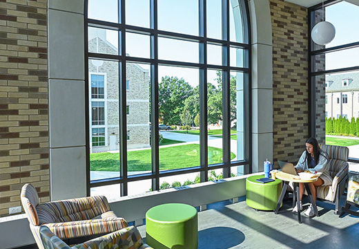 Student studying in brightly lit space of Lavery Library.